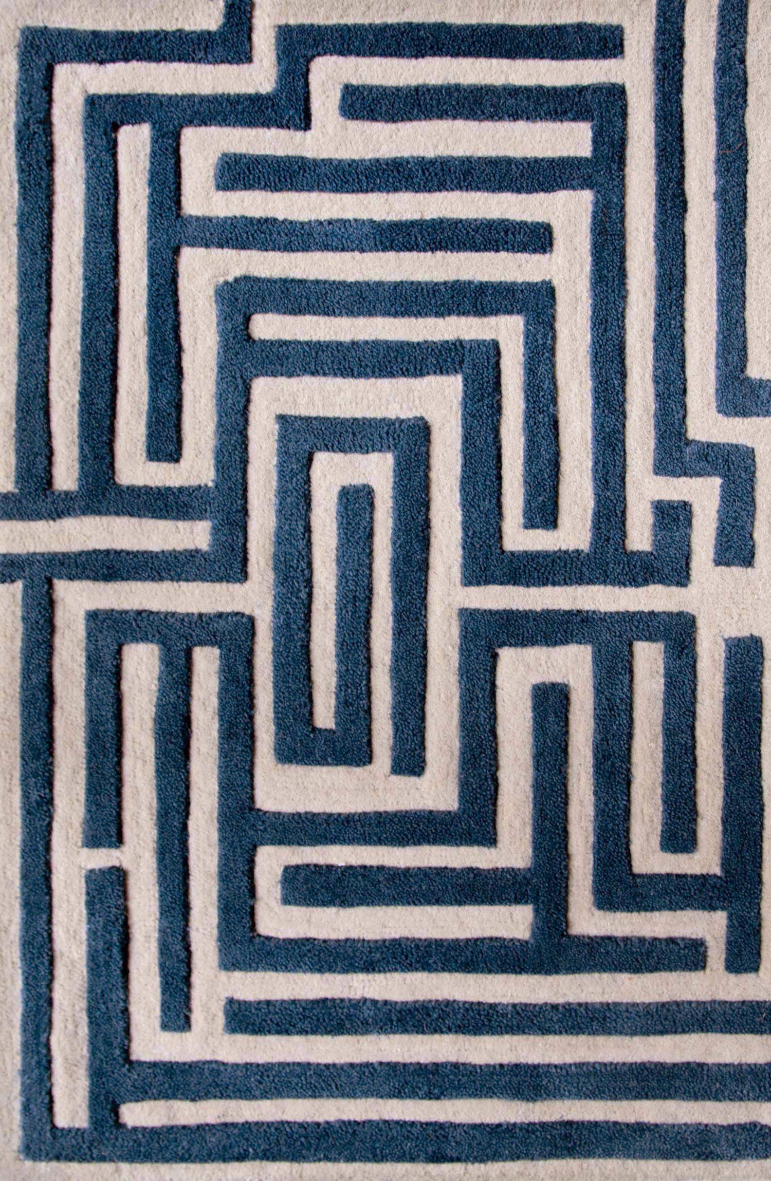 Maze luxury floor rug with a blueberry blue border outlining a beige maze