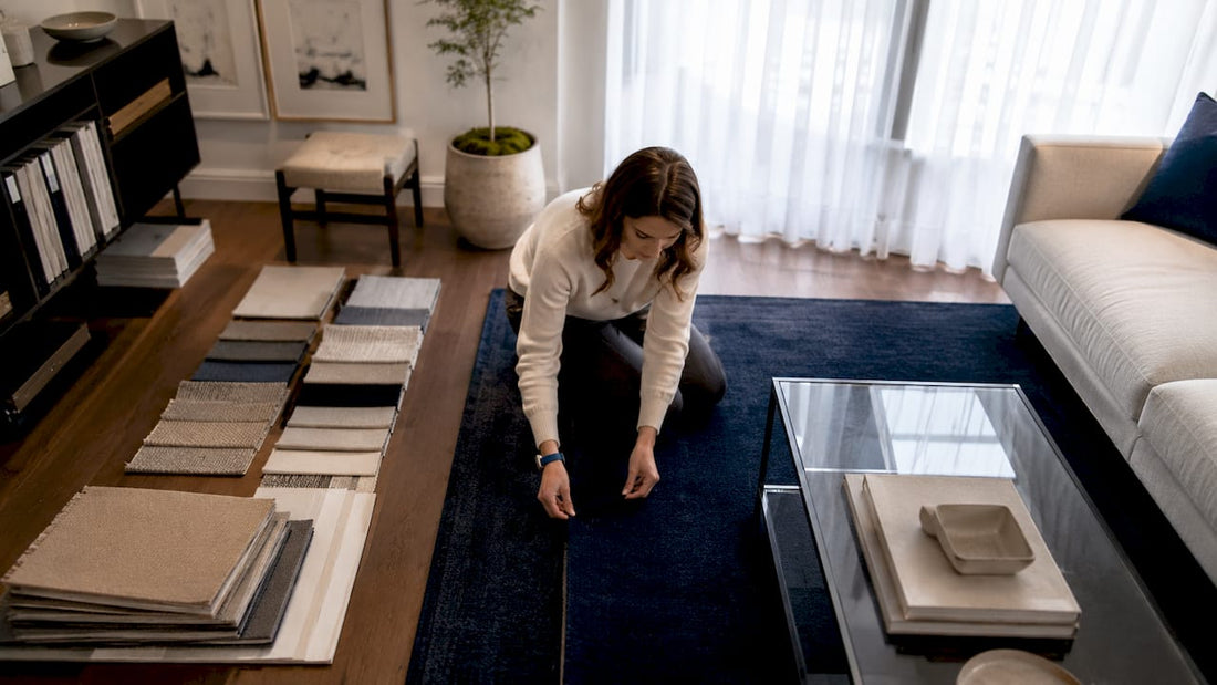 Designer positioning area rug in living room