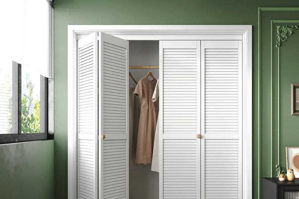 Louvered bifold closet doors with brass hardware in a modern classic bedroom