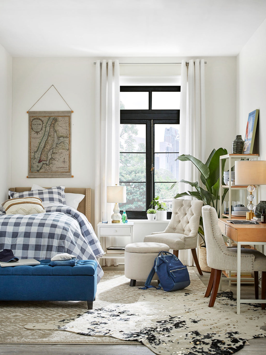 Kevin O'Gara modern dorm design for The Home Depot summer catalog with gray gingham duvet, blue storage bench, cowhide rug, and map wall hanging on Thou Swell #dorm #dormroom #dormdesign #backtoclass #homedepot