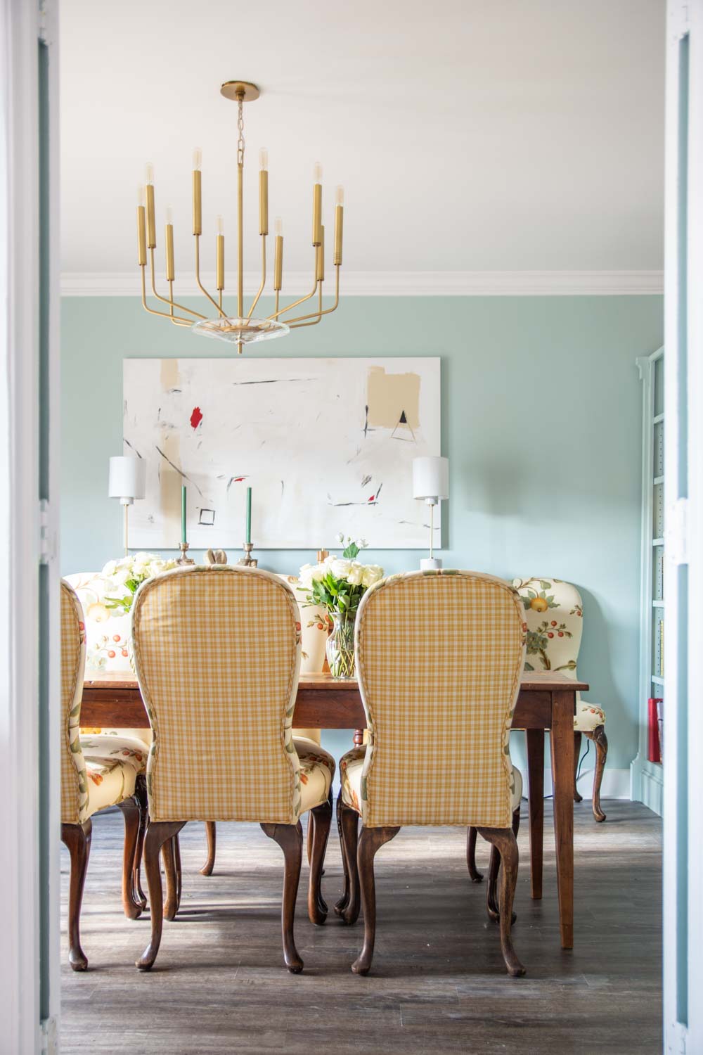 Light blue dining room with Clare Headspace paint color in Atlanta with antiques and modern Hudson Valley Lighting brass chandelier on Thou Swell #dining #diningroom #diningroomdesign #bluepaint #southernstyle #interiordesign #antiques