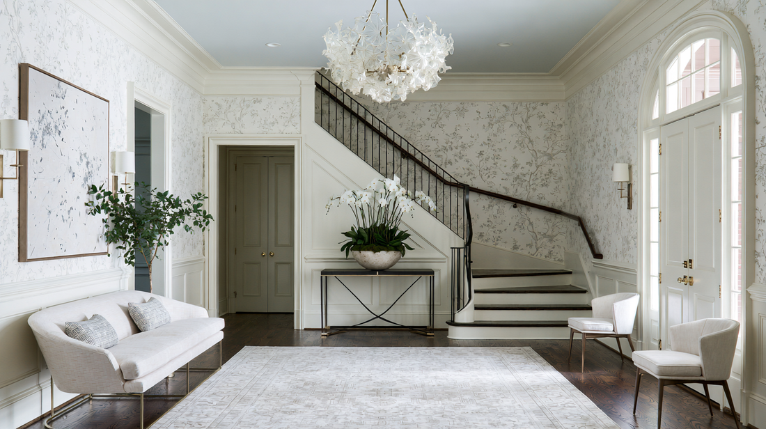 Modern classic Atlanta entryway with a statement mirror, layered lighting, and a patterned runner