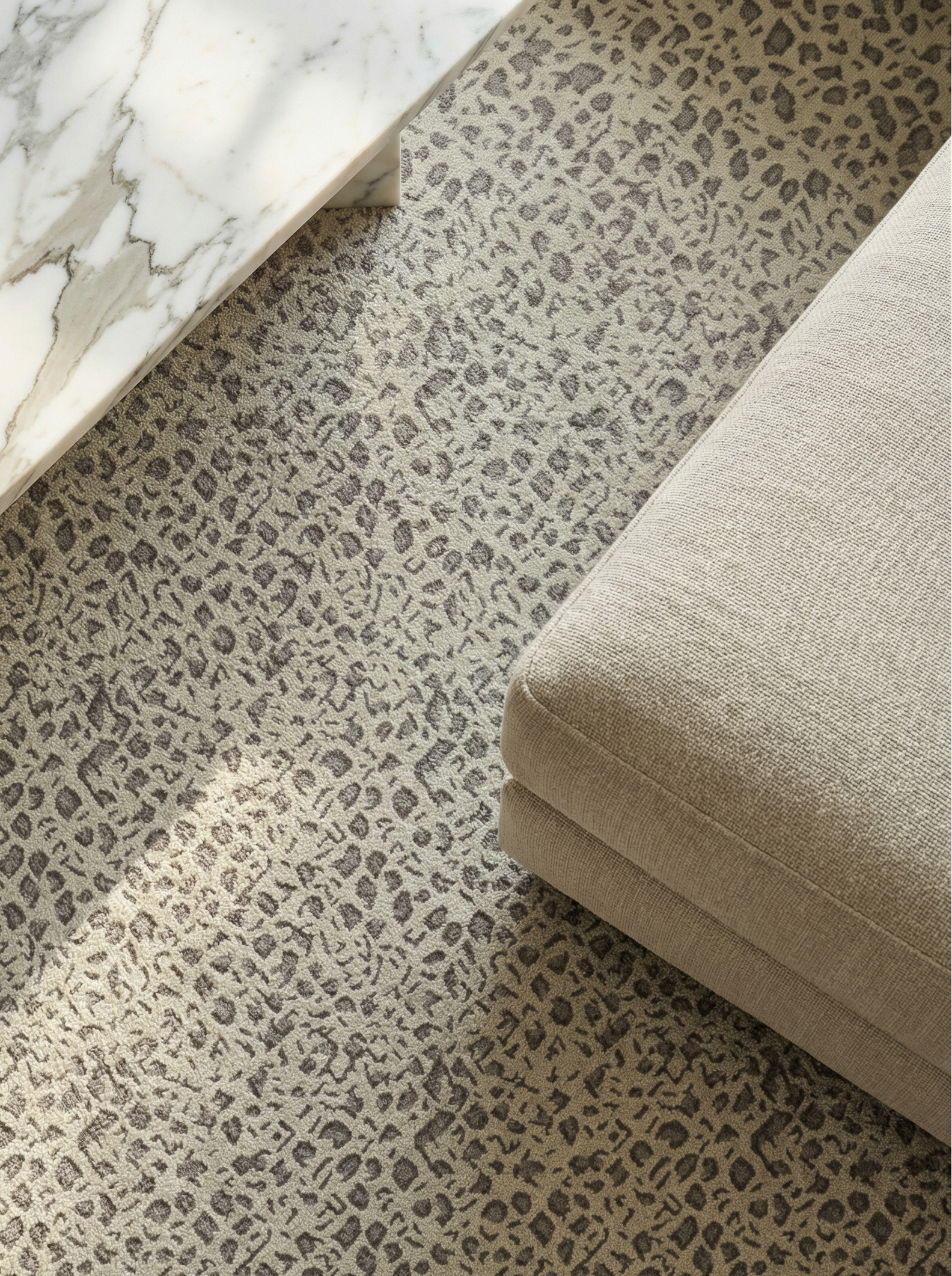 Leopard print performance rug with beige couch corner.