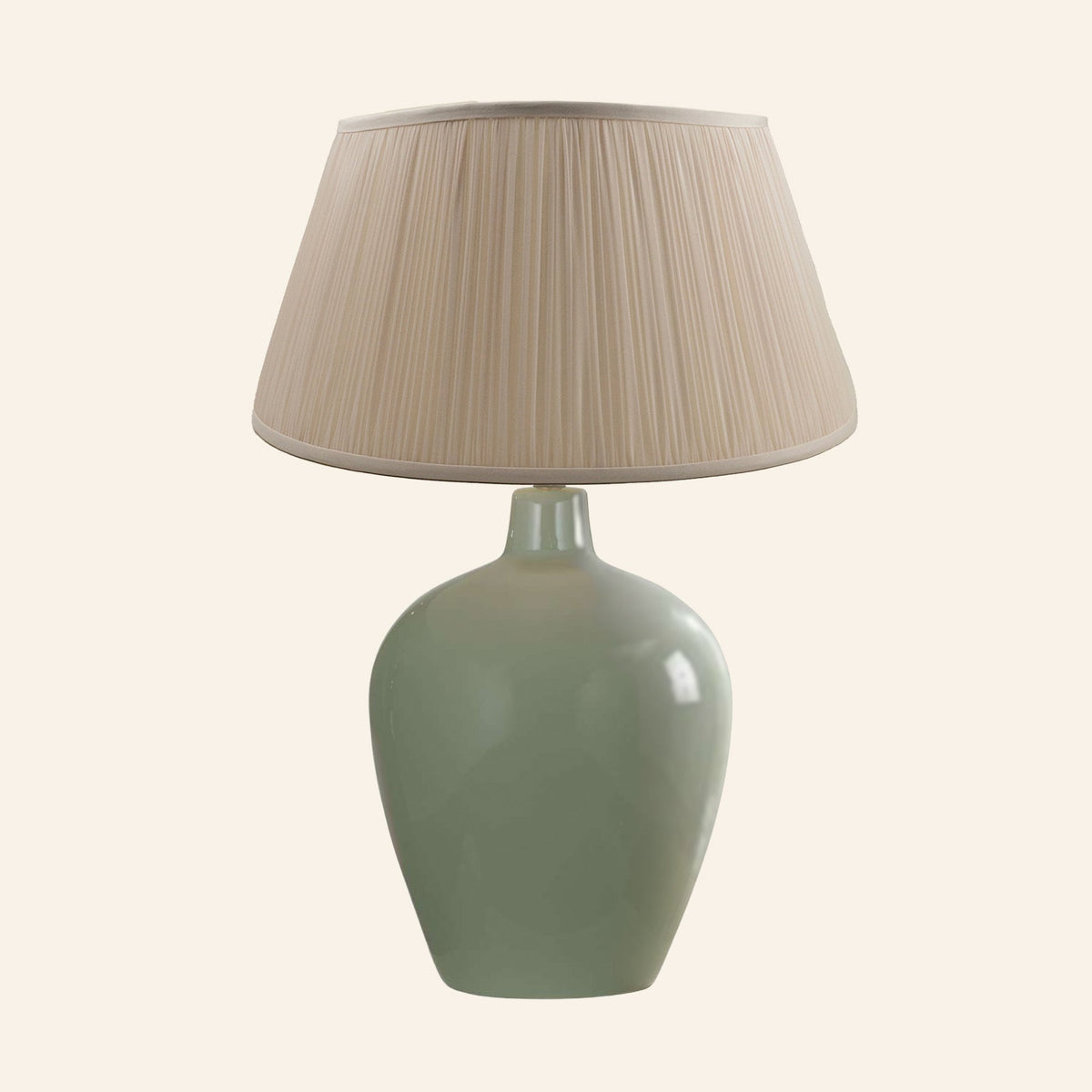 Ansley moss green ceramic table lamp with a Park Taupe silk pleated shade.