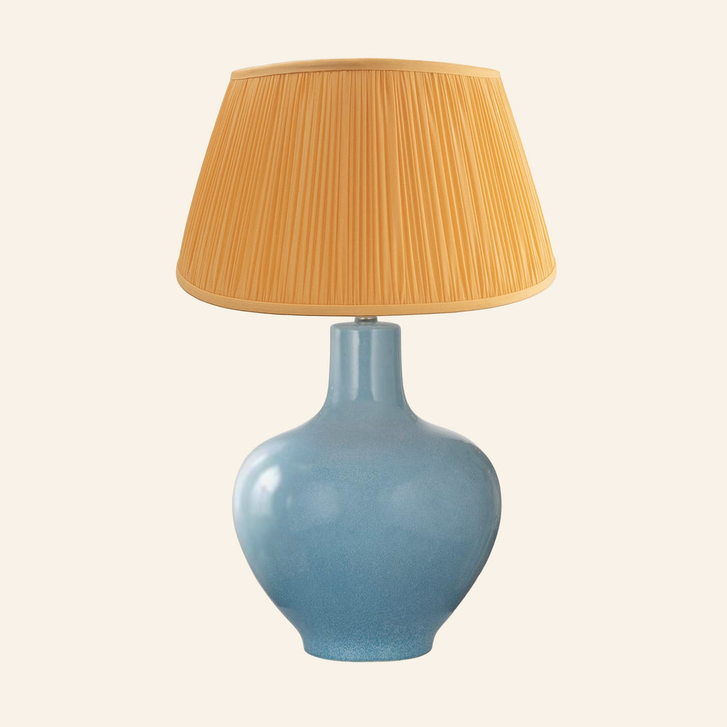 Celeste aqua blue glazed ceramic table lamp with a Park Orange silk pleated shade.