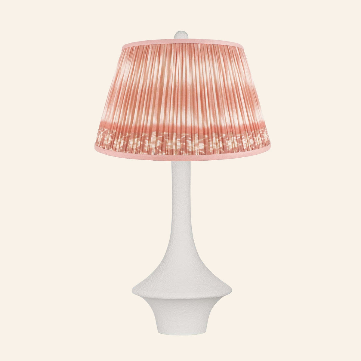 Constance matte white flared table lamp with a Coventry Coral ikat pleated shade.