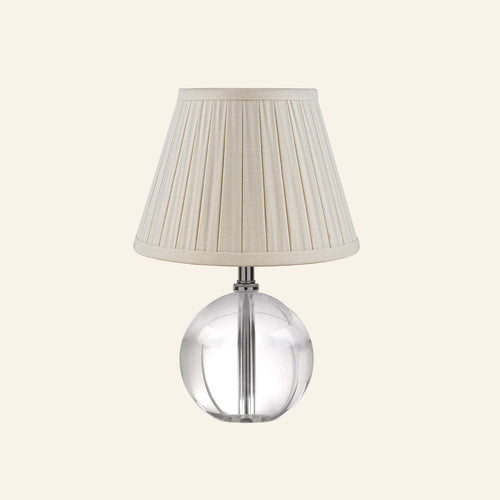Kevin Francis Design 14-inch Jane Glass Globe Mini Table Lamp with cream-colored shade and clear glass base.