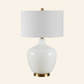 Sophia 22-inch wide white glass table lamp by Kevin Francis Design with a sleek, modern design and clear glass base.