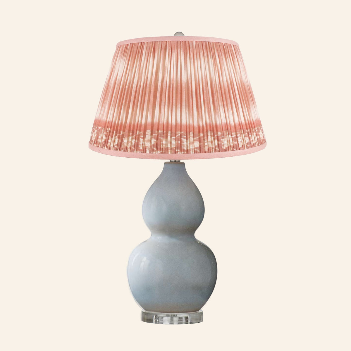 Vivienne gray blue double gourd ceramic table lamp with a Coventry Coral ikat pleated shade.