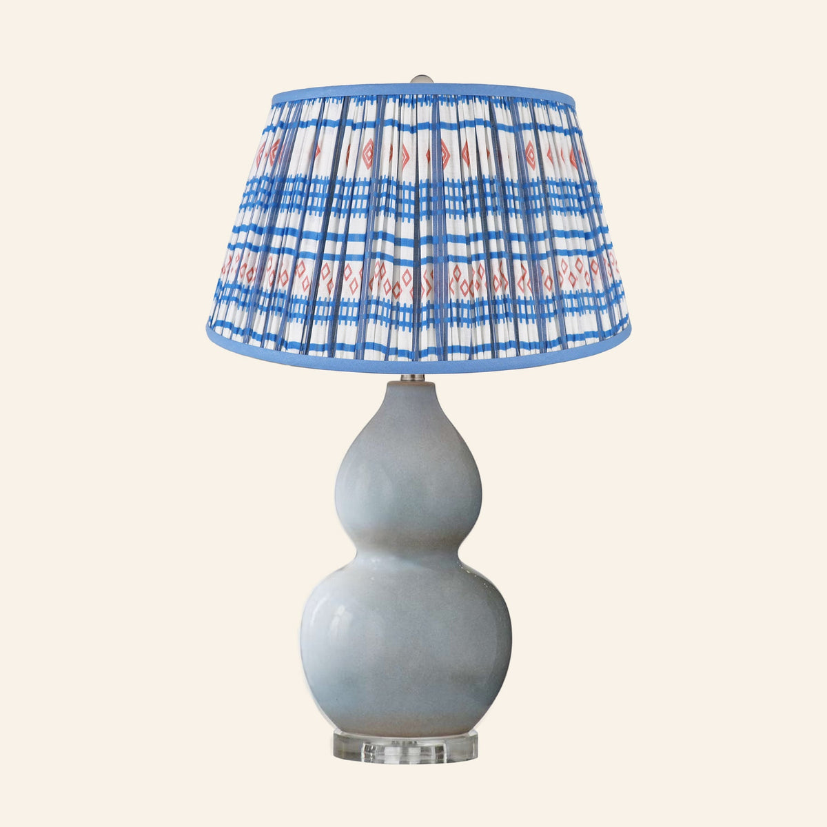Vivienne gray blue double gourd ceramic table lamp with a Fairfield blue and red print pleated shade.
