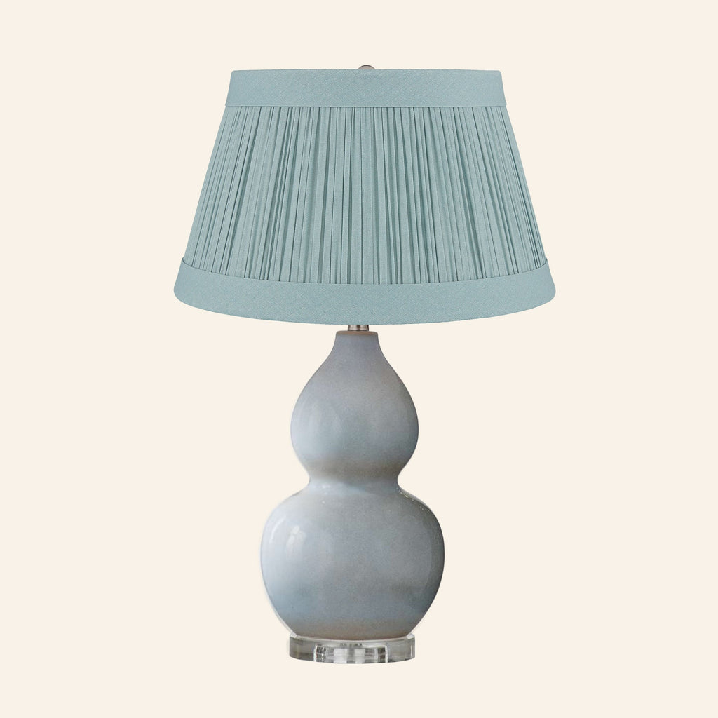 Vivienne gray blue double gourd ceramic table lamp with a Hill Teal linen pleated shade.