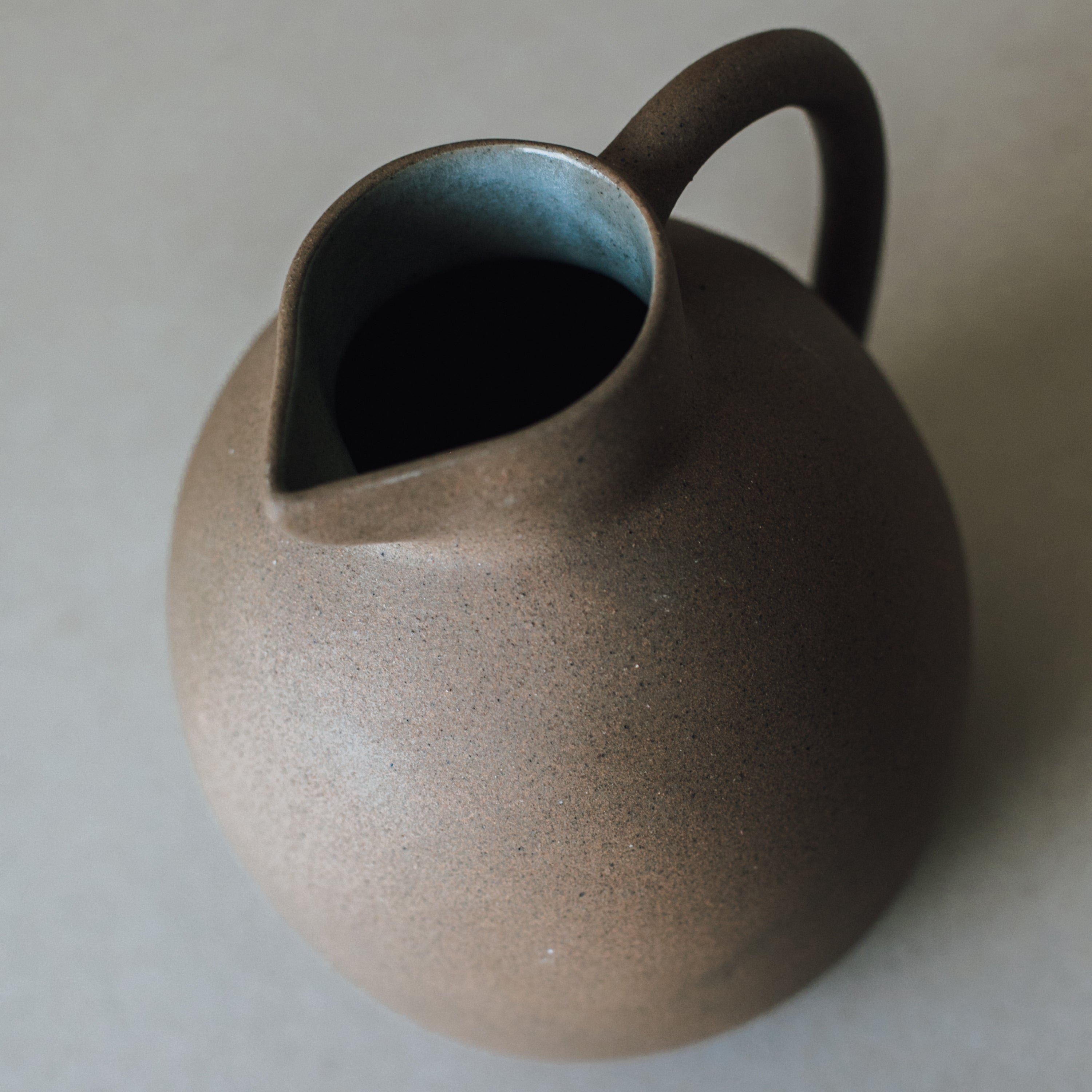 Handcrafted Clay Ball Pitcher by Kevin Francis Design | Luxury Area Rugs & Home Decor