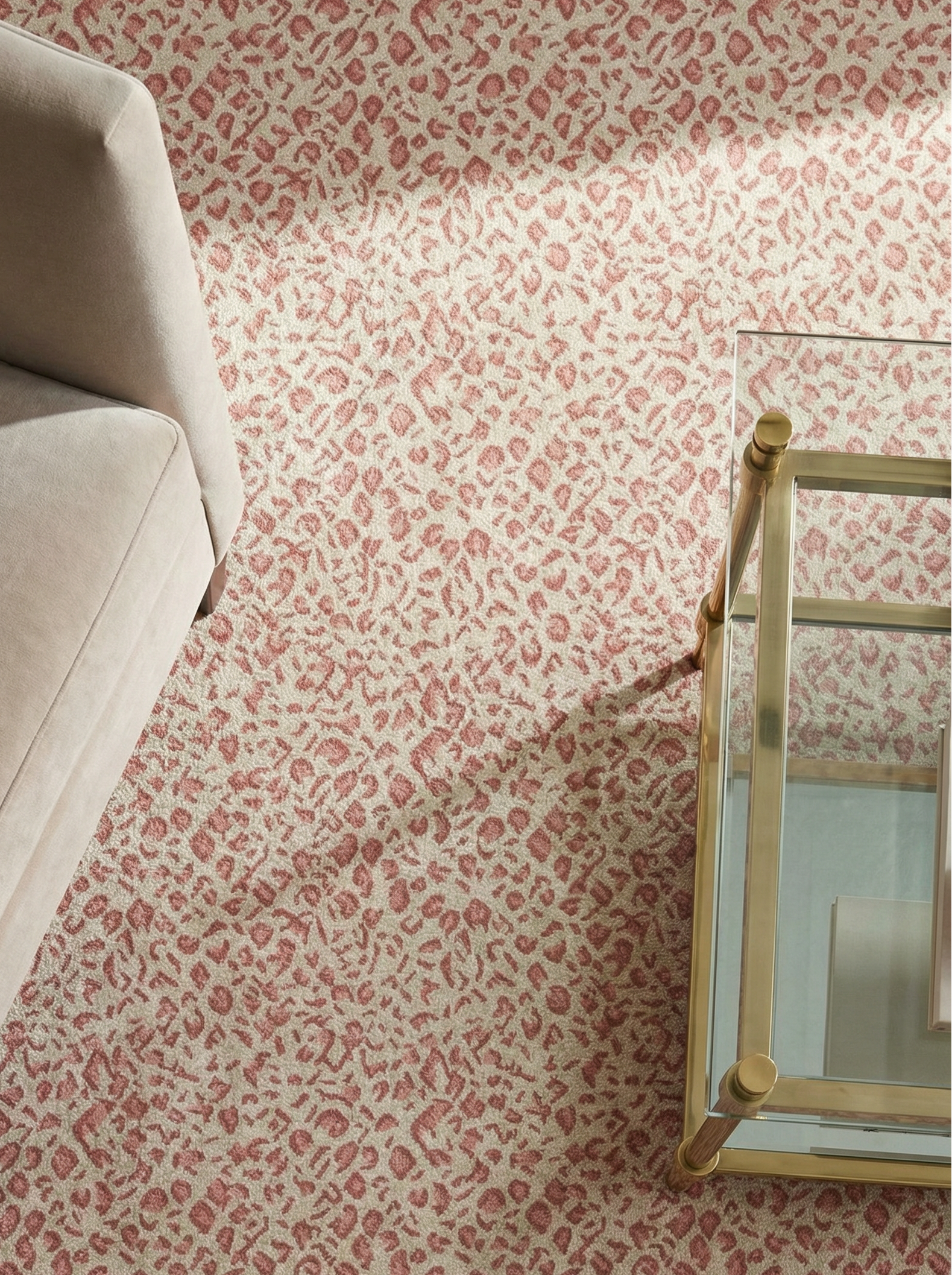 Pink leopard performance rug with chair corner and brass coffee table.