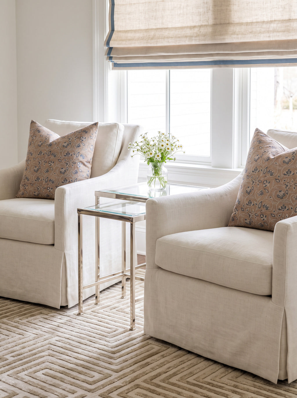 Broadland block print pillow covers styled on a pair of cream skirted swivel chairs