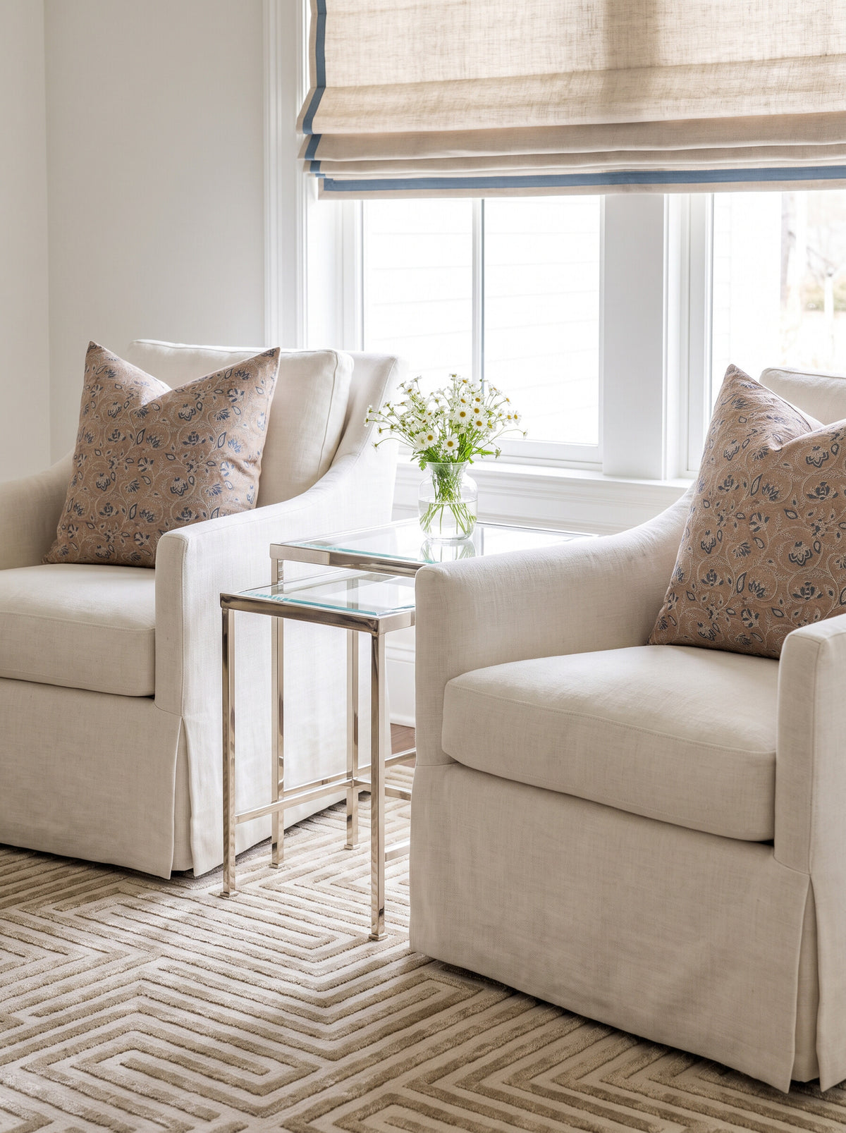 Broadland block print pillow covers styled on a pair of cream skirted swivel chairs