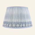 Blue Coventry Ikat printed pleated lamp shade by Kevin Francis Design, showcasing intricate ikat pattern and elegant pleats.