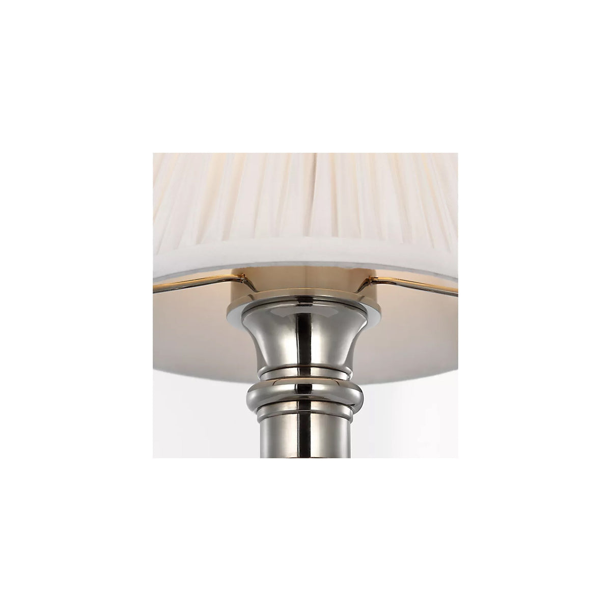 Detail of the turned silver column base and pleated silk shade on the Ellis cordless lamp by Kevin Francis Design