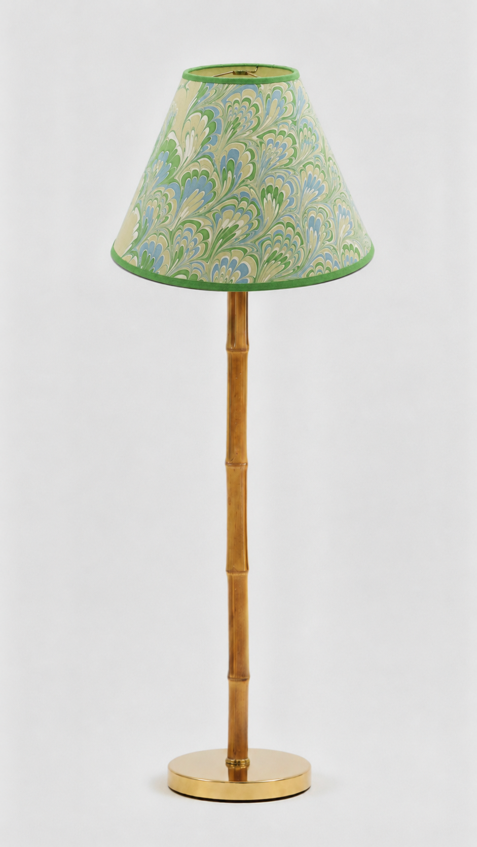Caslon green marbled empire lamp shade shown unlit on a slim brass lamp base.