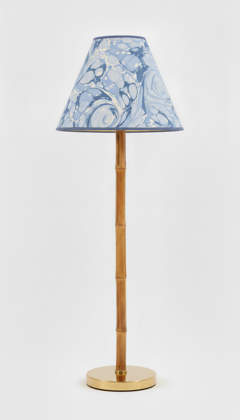 Chiswick marbled empire lamp shade shown unlit on a slim brass lamp base.
