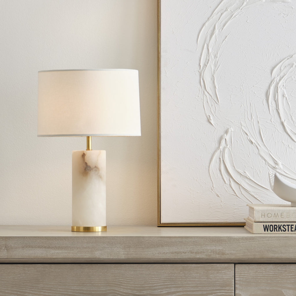 Hayes alabaster cordless table lamp lit on a console by Kevin Francis Design