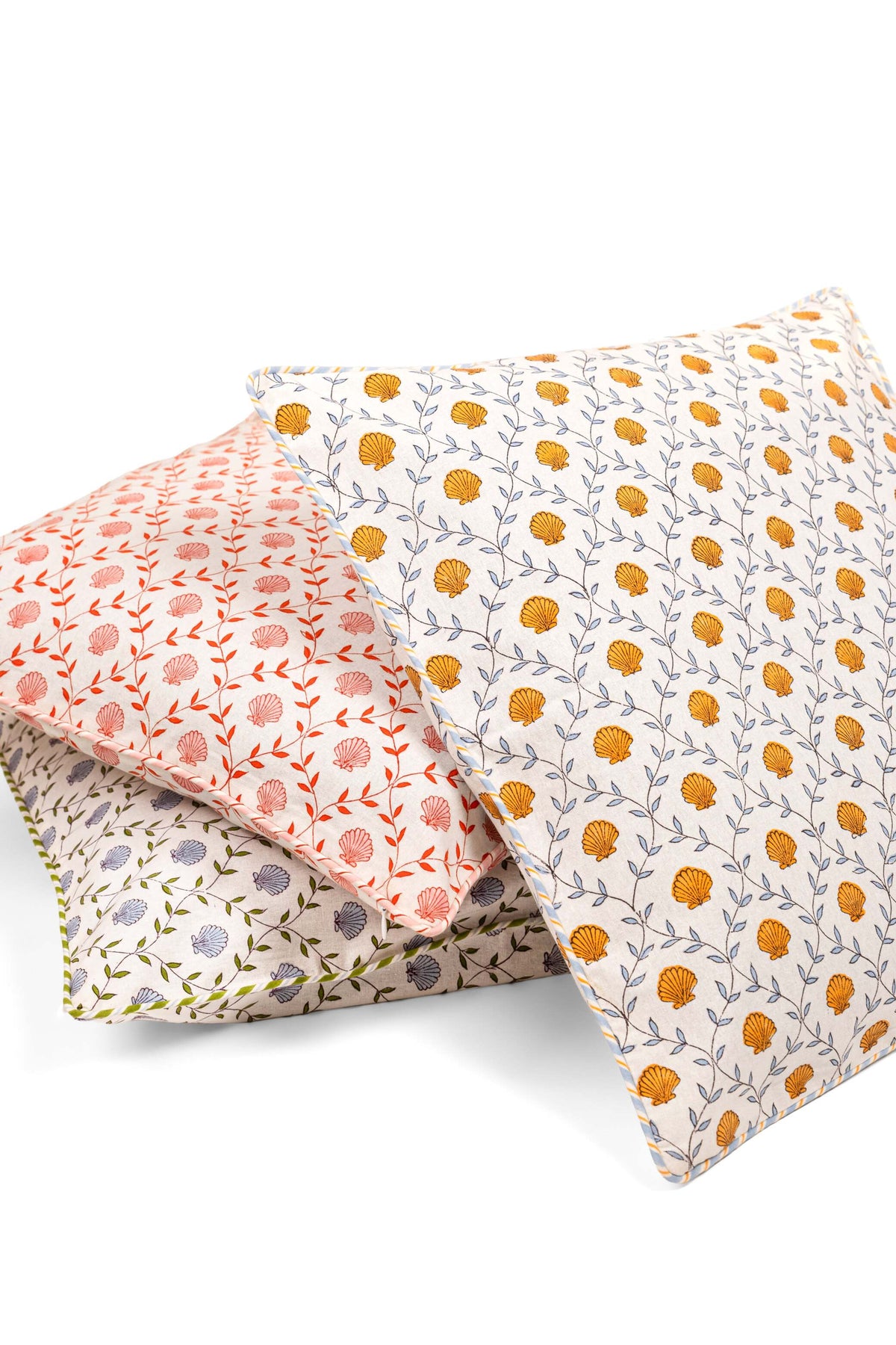 The Chatham blue seashell block print pillow cover styled on a sofa