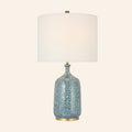 25-inch Imogen cordless table lamp with a speckled blue glazed ceramic bottle base, brass foot and white linen drum shade, by Kevin Francis Design