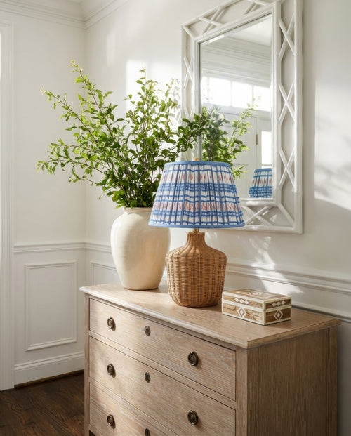 22-inch Lillian woven rattan wicker table lamp by Kevin Francis Design on a cerused oak Italian chest in an entry foyer.