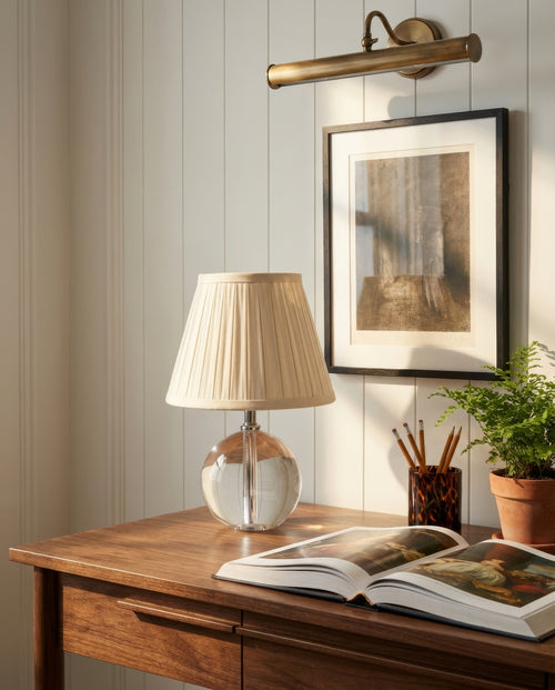 14-inch Jane Glass Globe Mini Table Lamp by Kevin Francis Design on a midcentury walnut desk in an interior setting.