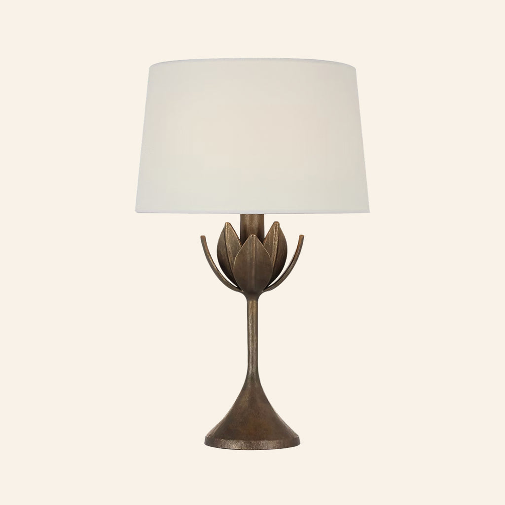 17-inch Julian cordless table lamp in antique bronze leaf, a slender stem opening into a crown of leaves under a white linen shade, by Kevin Francis Design