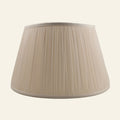 Beige Park Shirred Silk Pleated Lamp Shade by Kevin Francis Design hanging on a lamp. Elegant, textured silk with shirred pleats.
