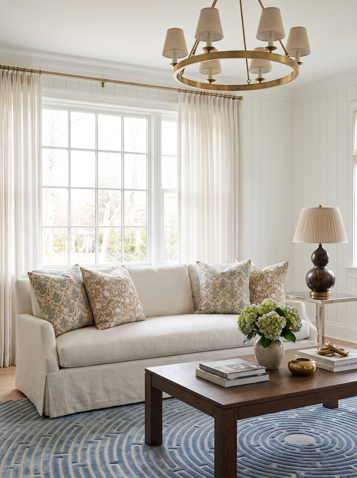 Pharr and Bolling block print pillow covers on a cream slipcovered sofa beside the Henrietta smoked brown table lamp